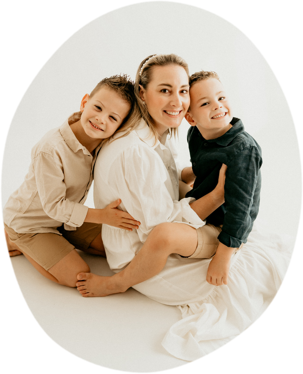Author Hannah Marks smiling, sitting with her two young sons.